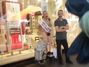 FERRARI PRESS AGENCY - 24/09/15 - Image of nearly naked Kay Bishop, 56, glued her bum to Debenhams in Croydon to protest about migrants and the police. Photo by @busrxoz - SEE FERRARI COPY